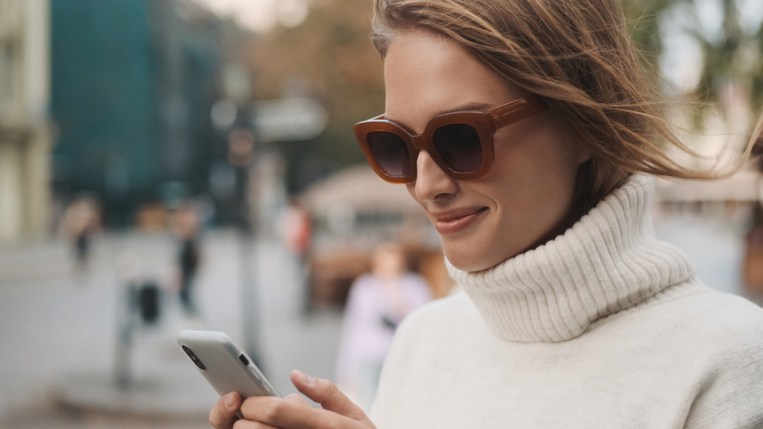 Beautiful stylish girl in sunglasses dressed in white cozy sweat